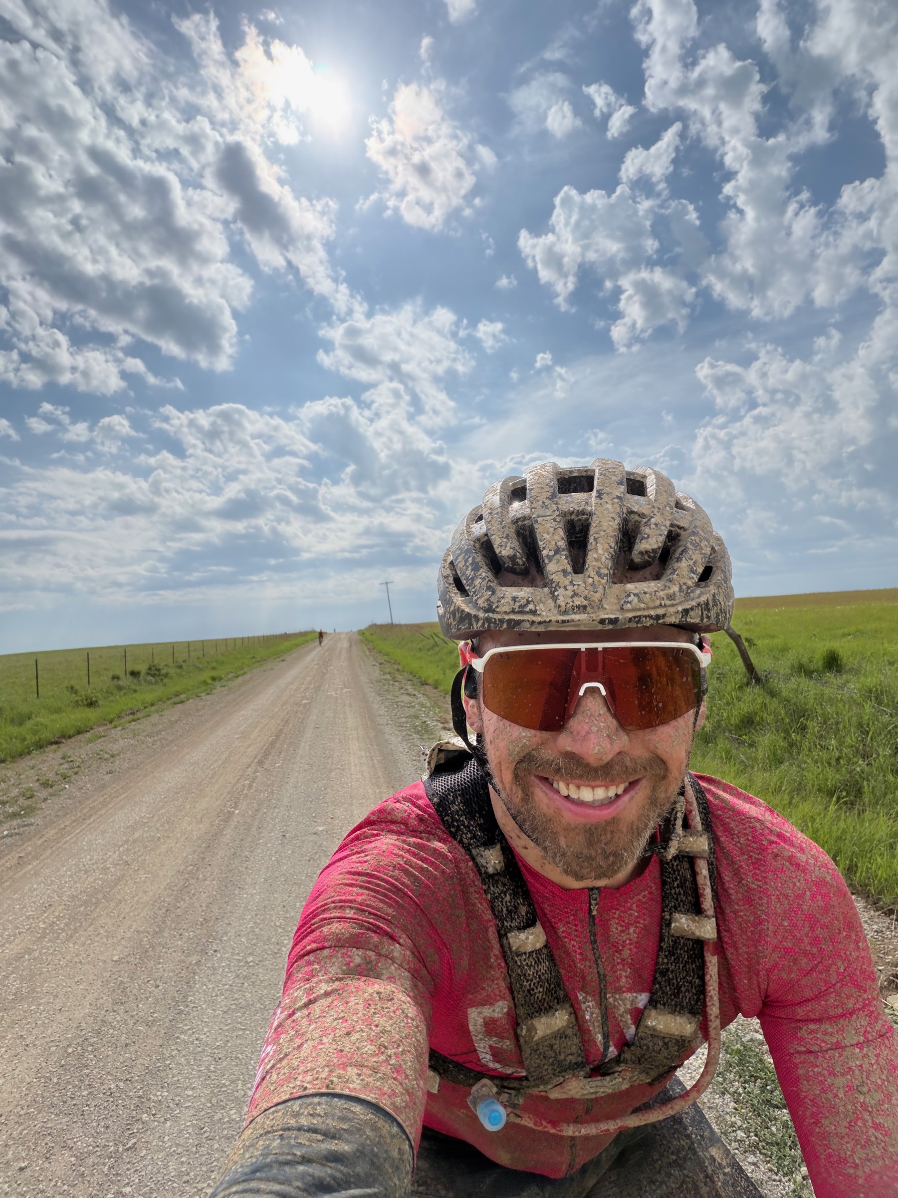 John Wintersteen muddy and smiling during Unbound Gravel