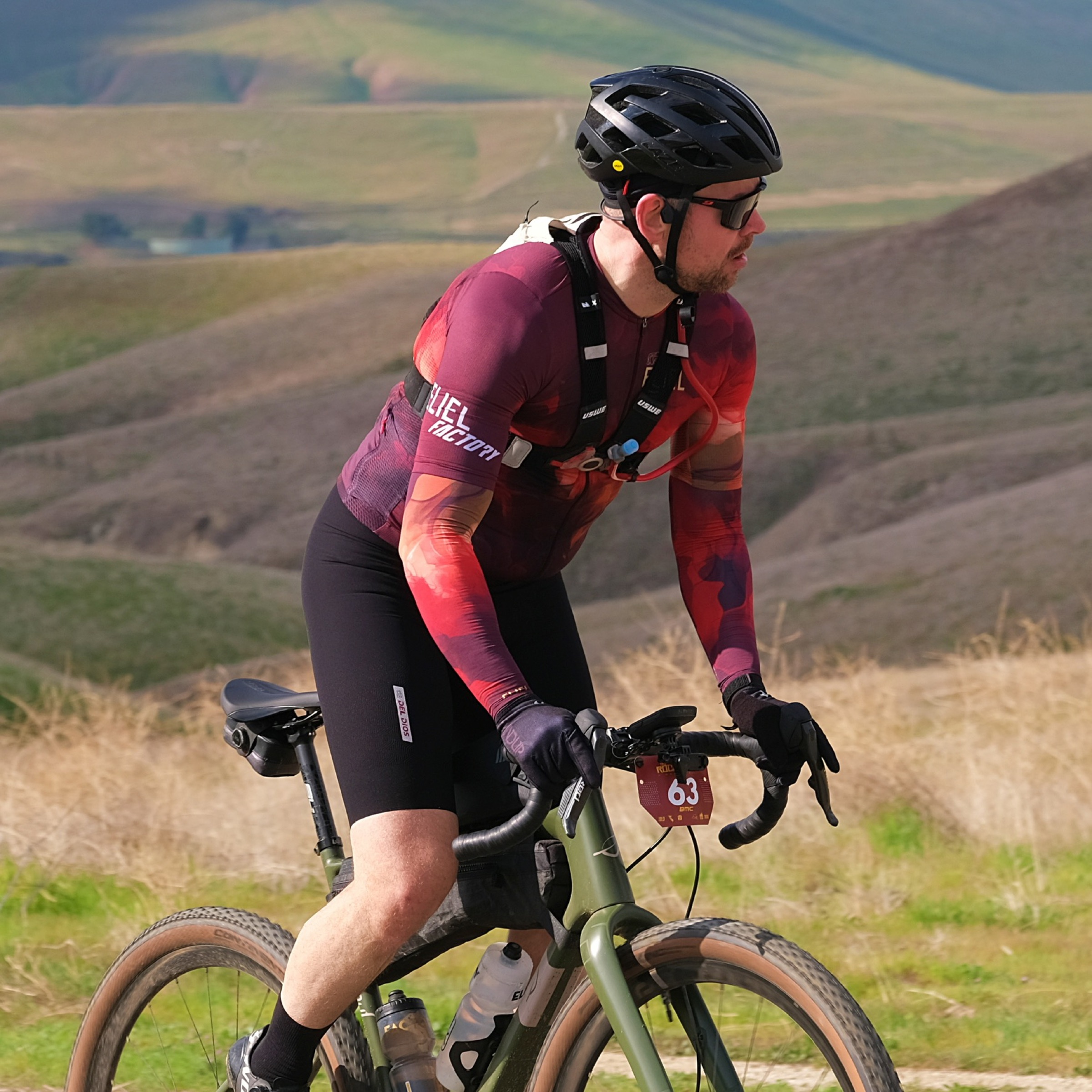 John Wintersteen riding in rolling terrain